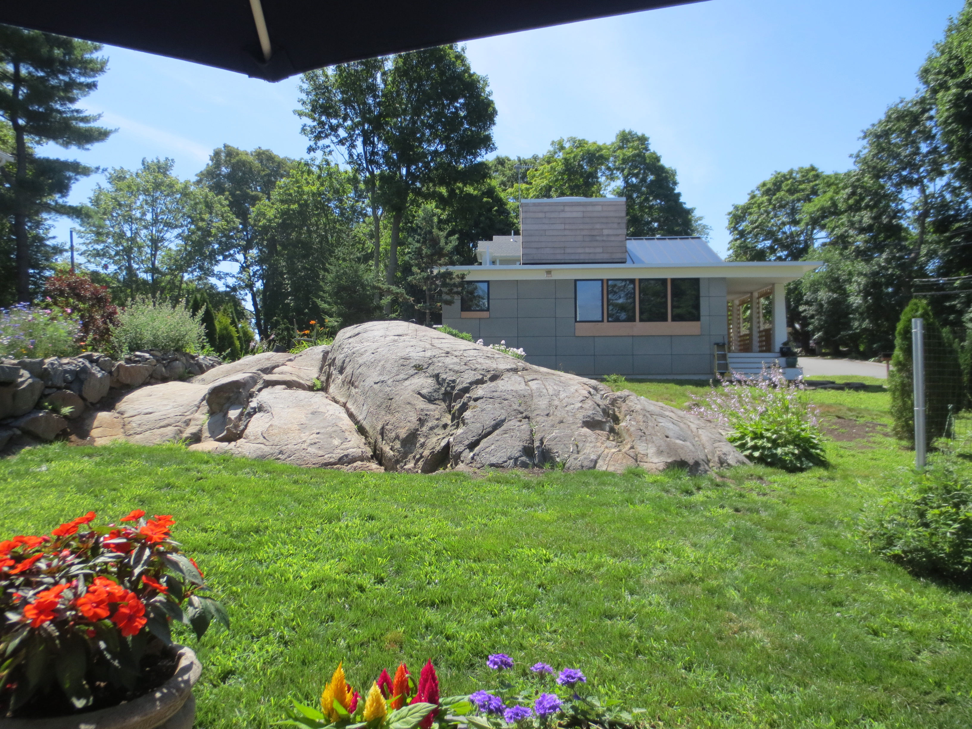 Modern home integrated with a large natural rock